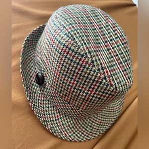 Herringbone hat with brown leather details.